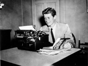 John F. Kennedy at a typewriter with his book "Why England Slept," circa 1940. Photo credit John F. Kennedy Presidential Library and Museum, Boston.