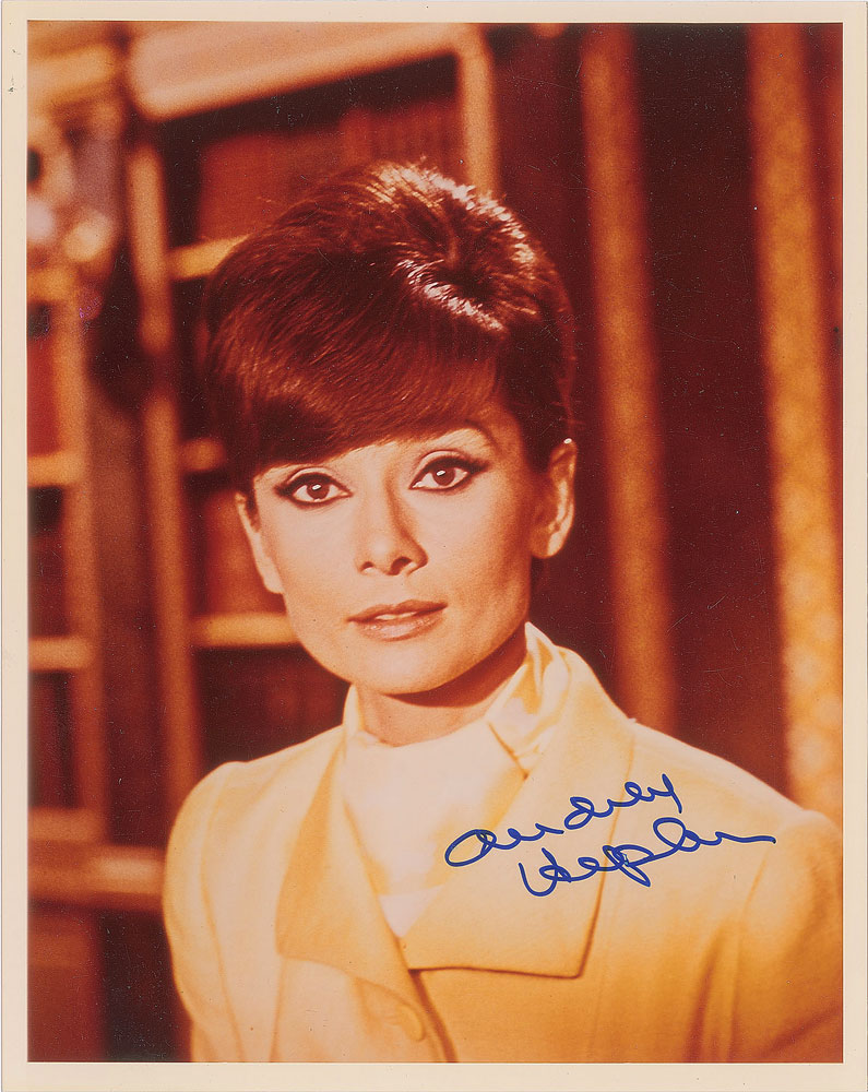 Audrey Hepburn autographed color glossy 8 x 10 photo from 1966 film “How to Steal a Million.” Part of the John Brennan In-Person Autograph Collection. Offered by RR Auction.