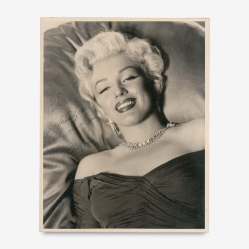 Marilyn presents a glamorous oversized portrait to her beloved choreographer and confidant Jack Cole