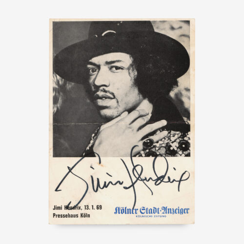 Exceptional vintage 4 x 5.75 cardstock promo photo produced especially for a one-off concert at the Sporthalle in Cologne, Germany, on January 13, 1969, prominently signed in black felt tip, "Jimi Hendrix."