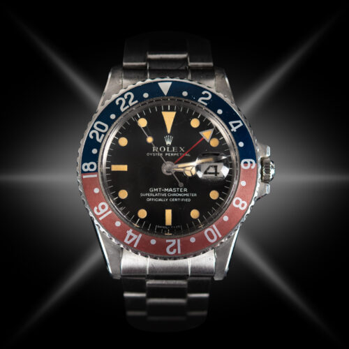 26-jewel Oyster Perpetual Movement, black dial, blue-and-red bezel with 24-hour scale (nicknamed the 'Pepsi' color scheme), date indicator with famous Rolex 'Cyclops' magnifying bubble in the acrylic crystal, and Rolex Steelinox bracelet with fliplock clasp